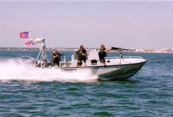 Small coast guard boat speeding across the water