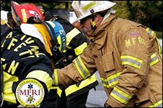 Close up of a group of firefighters mid-training in full gear