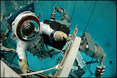 Diver in a pool training for zero-G exercises at the Neutral Buoyancy Research Facility