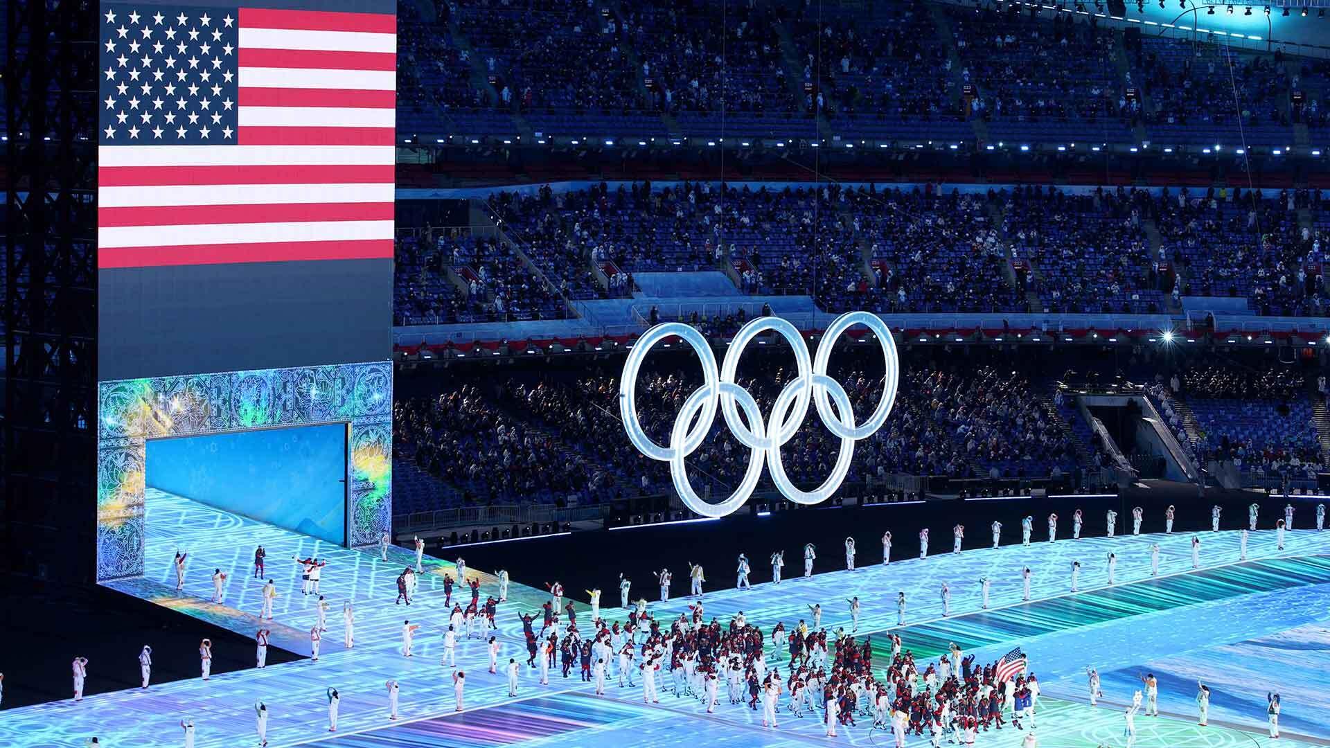 Brittany Bowe and John Shuster of Team United States carry their flag during the opening ceremony of the Beijing 2022 Winter Olympics at a half-full National Stadium on Friday.