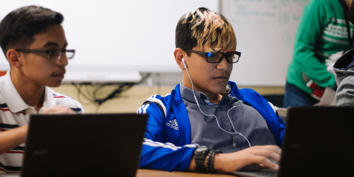 Students looking at laptops