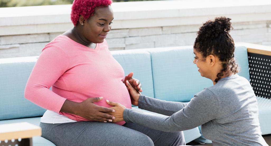 Pregnant black woman with doula