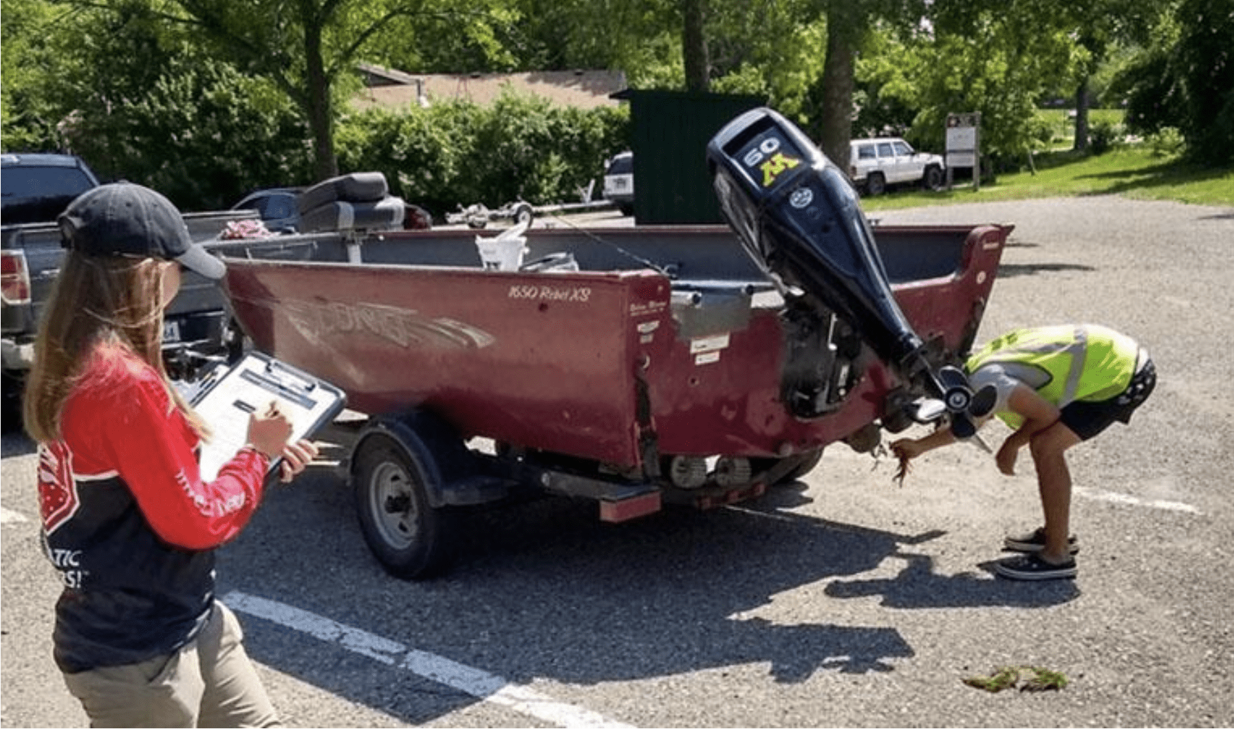 Nichole Angell, a graduate research assistant from the University of Minnesota, evaluates a watercraft inspector completing a boat inspection.