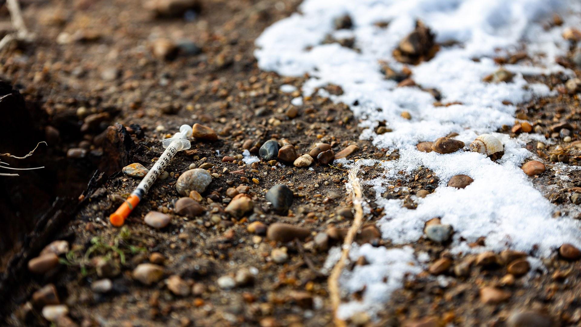 A discarded drug needle left on the ground